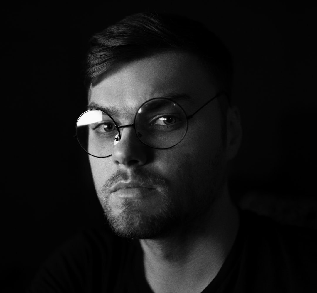 Studio portrait of a man in his 30s with glasses