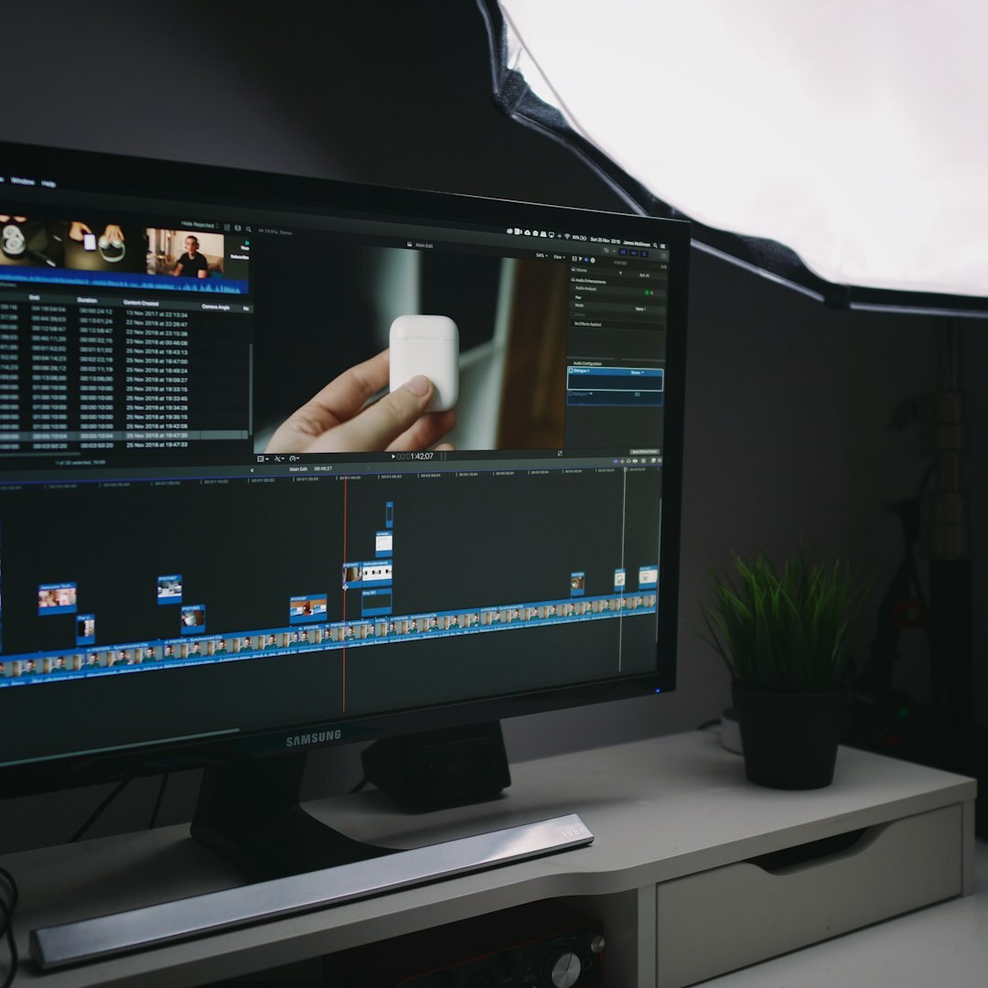 Editor reviewing footage on a laptop at an editing desk